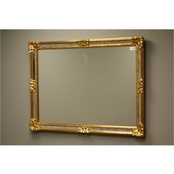  Rectangular mirror in gilt cushioned frame, 68cm x 95cm  