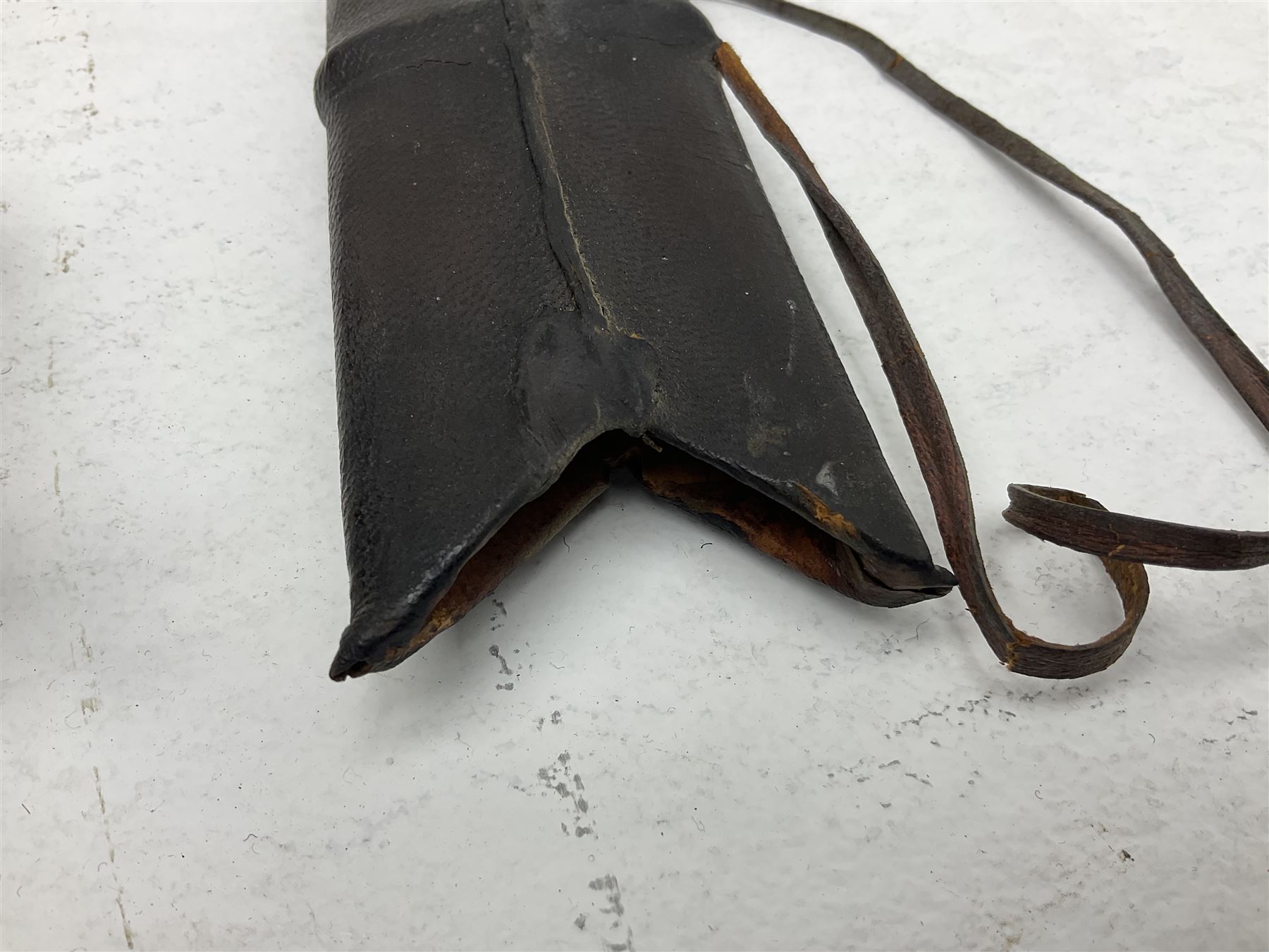 Late 19th/early 20th century Indian Tulwar sword with 81cm plain curving steel blade and iron hilt with extended langets, knucklebow and spiked pommel; in leather covered scabbard L100cm overall; and another Tulwar lacking scabbard in almost relic condition (2)