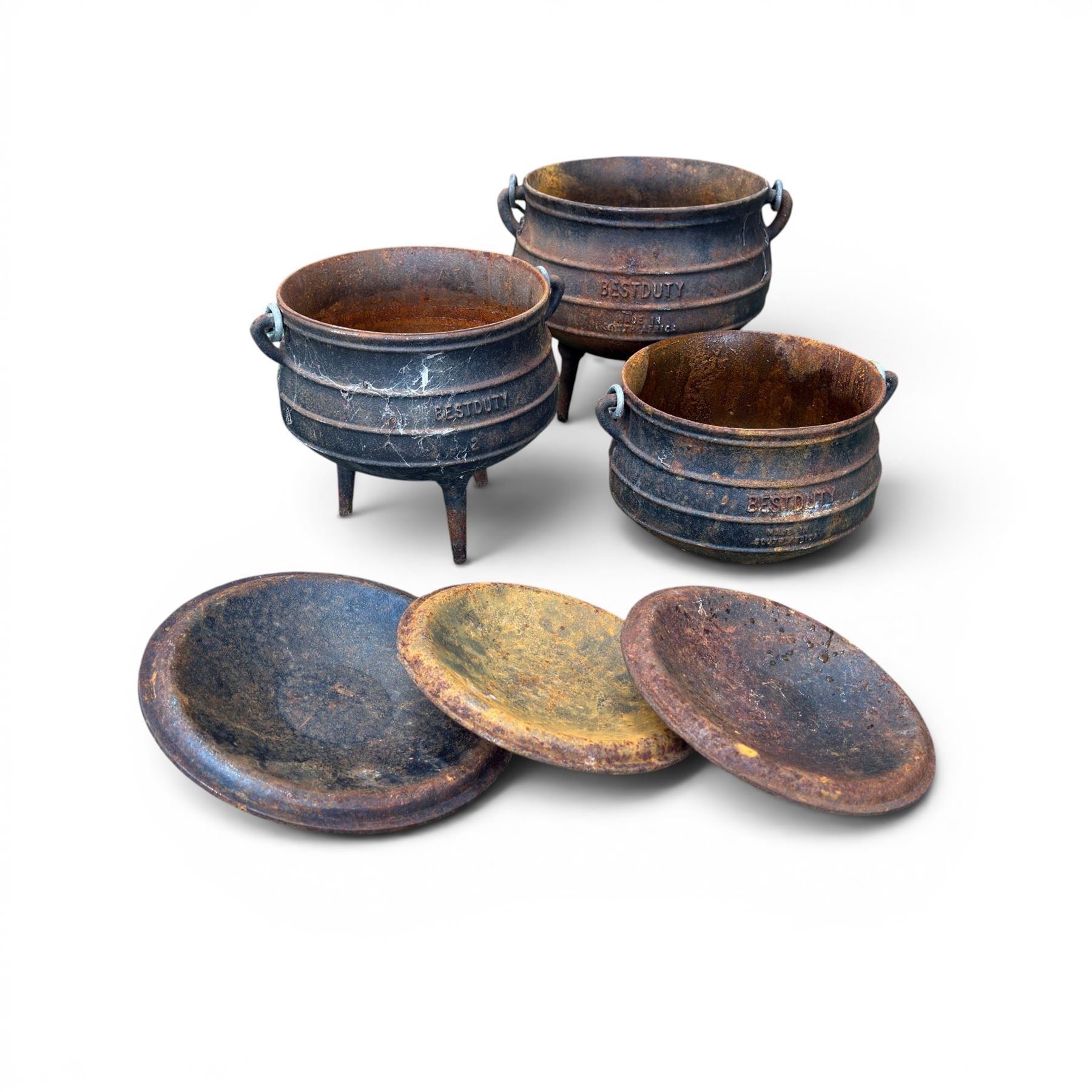 Three South African cast iron graduating cooking pots with lids and handles. Size shown for the largest