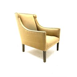Regency shaped armchair upholstered in studded fabric, square tapering supports
