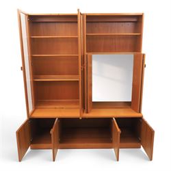G-Plan - Mid 20th century teak modular wall unit, the upper section fitted with twin glazed doors enclosing shelves, adjoining concertina doors with mirrored and shelved interior, the base with four cupboard doors with recessed rectangular handles, raised on a plinth base