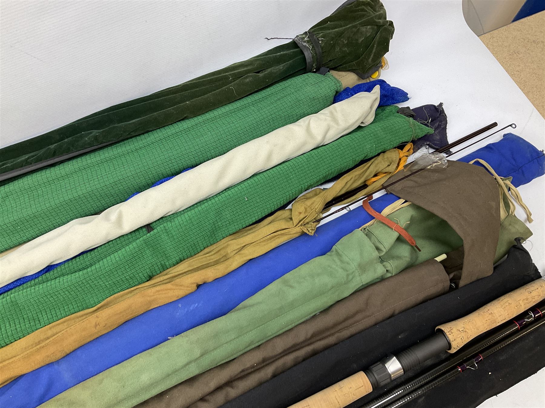 Twelve carbon fiber fishing rods in cloth covers, to include Normark fishing rod, Daiwa Carbon C98 etc (12)
