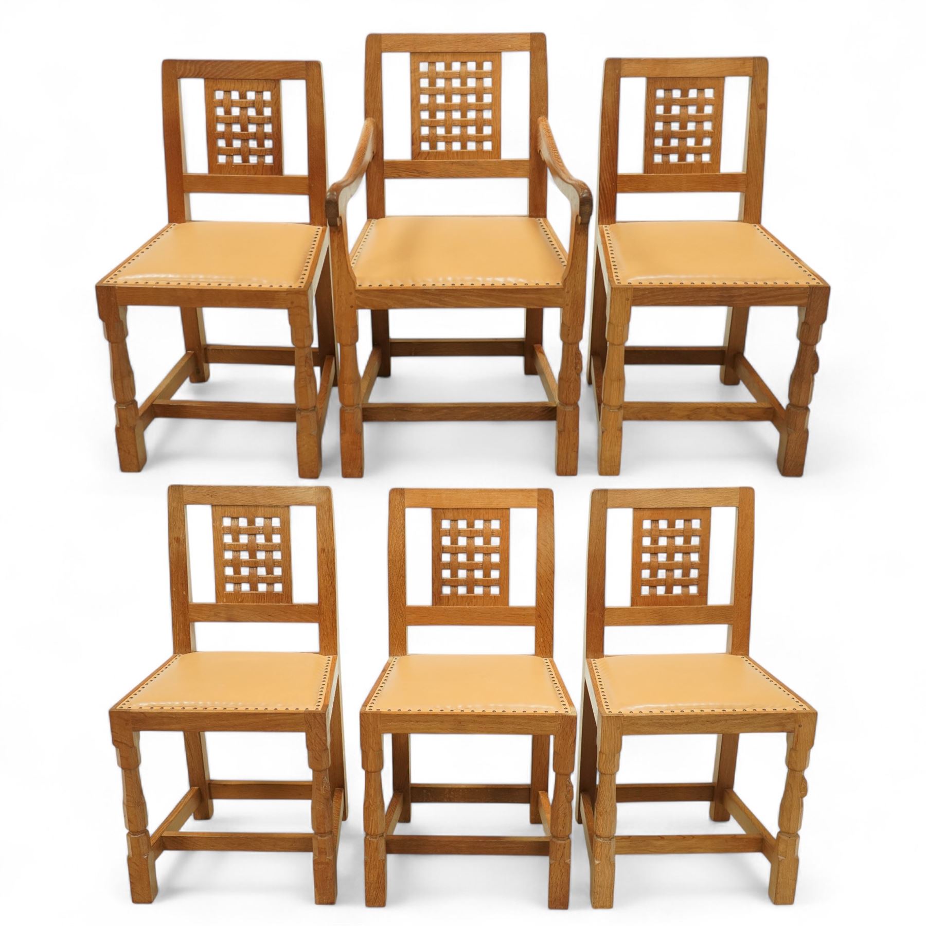 Mouseman - set of six oak dining chairs (5 + 1), pierced and carved lattice back over leather upholstered seat, on octagonal front supports united by stretchers, carved with mouse signature, by the workshop of Robert Thompson, Kilburn