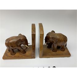 Pair of elephant bookends, carved wall plaque of a bird amongst branches, twin handled tray with inlaid decoration, book slide, carved head, circular carving decorated with rhinos, and other carved African ornaments etc