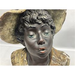 19th century plaster bust of a young boy wearing a hat, upon black painted socle base, H46cm