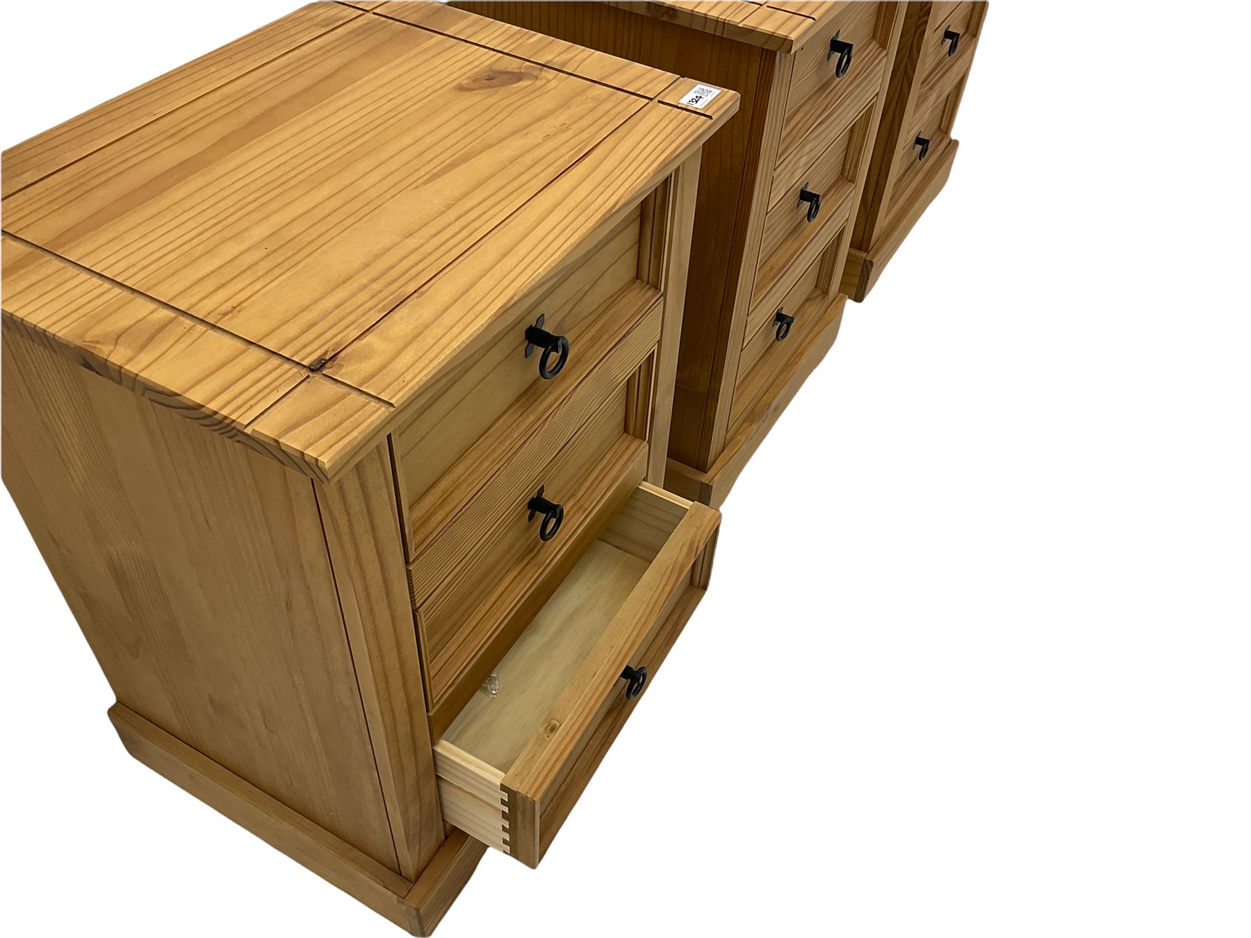 Pair of pine three drawer bedside chests, black iron handles The