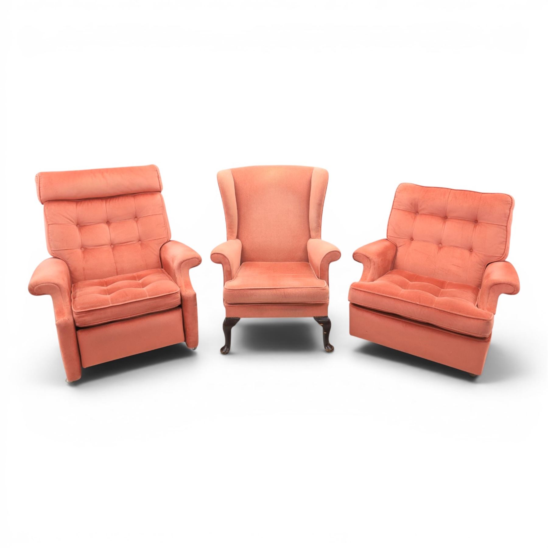 Parker Knoll - mid-century armchair suite, 'Model N30' recliner armchair with headrest and deep buttoned seat and back raised on castors, a wide armchair with deep button back and seat raised on castors, a wingback chair with flared scrolled arms, raised on cabriole supports
