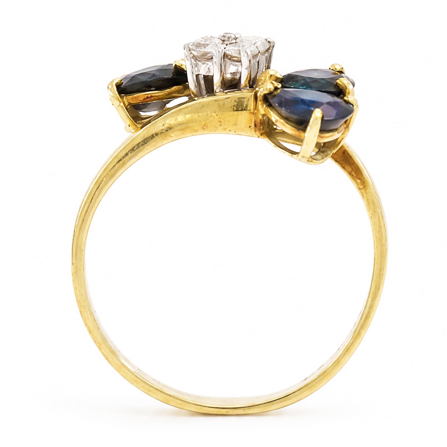 18ct gold sapphire and diamond crossover ring, four round brilliant cut diamonds, each finial set with two pear cut sapphires, London 1978