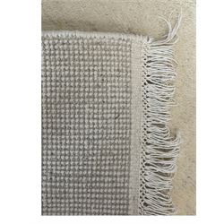 Contemporary Kayam hand-knotted Indian rug, plush wool pile in plain cream, ivory fringed edges on both sides 