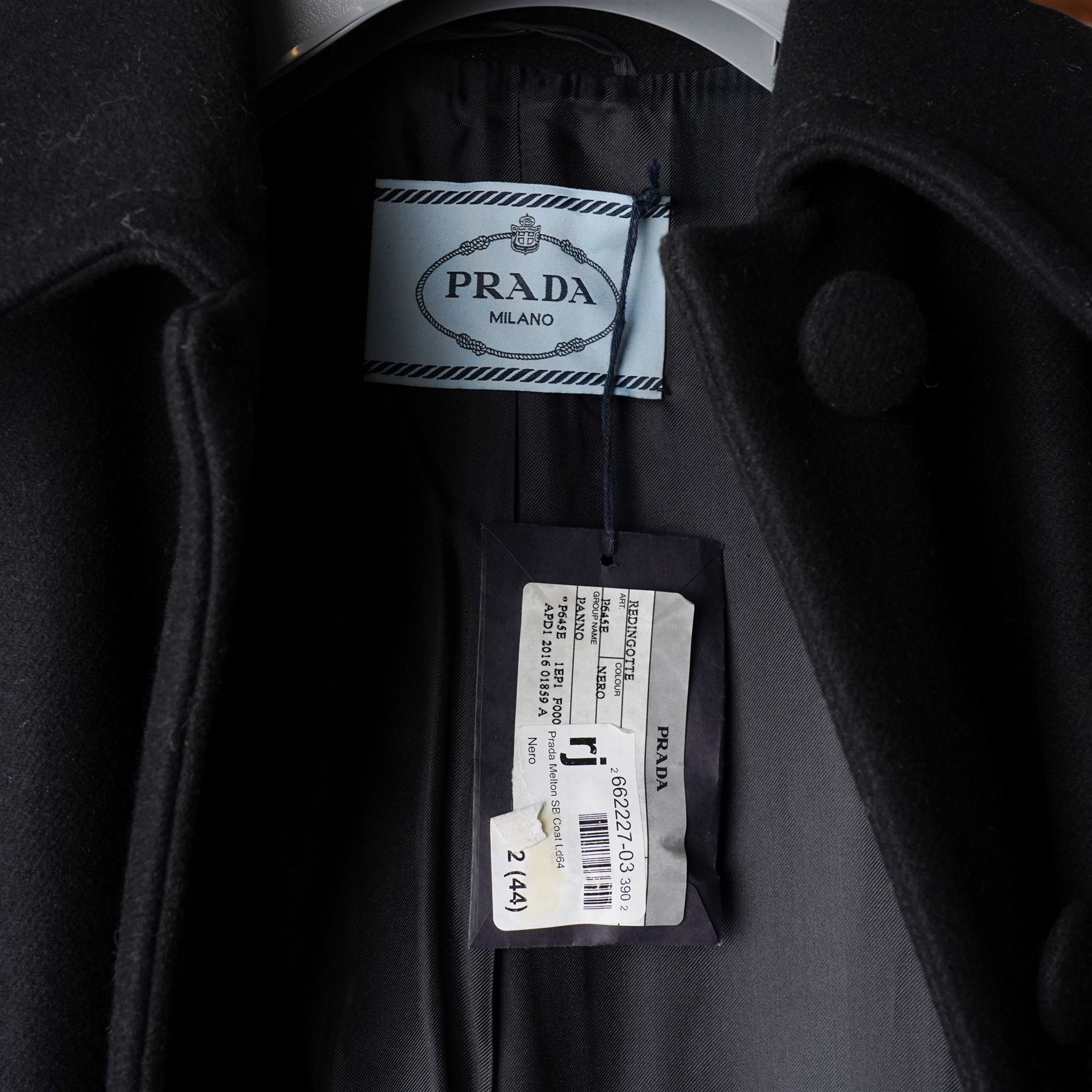 Prada - black Melton wool coat, in a redingote style with front fastening and fabric-covered buttons, flap pockets and a structured collar with slit to the back, size 44, unused with the original garment bag and hanger