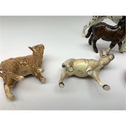 Group of Beswick figures, comprising lion, recumbent box and smaller fox, donkey, calf, smaller Highland calf, foal, pony, and dalmatian. 