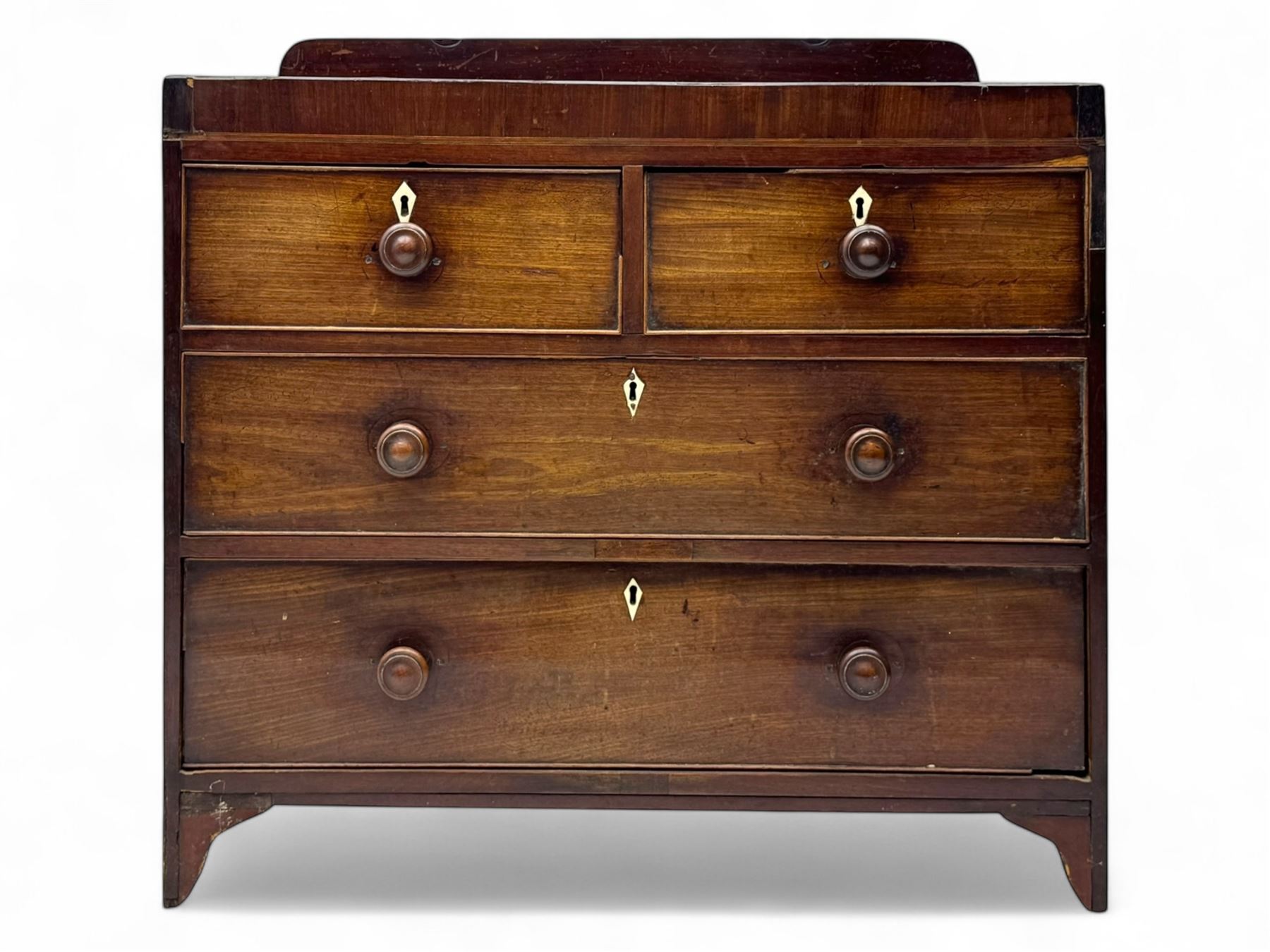 19th century mahogany chest, rectangular top with raised gallery back, fitted with two short and two long cockbeaded drawers, each with bone escutcheon, on shaped bracket feet
