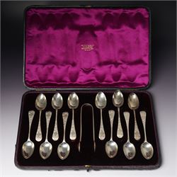 Cased set of twelve Victorian silver tea spoons and tongs with floral engraved stems Londo...