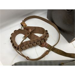 Assorted militaria including ten leather or canvas cartridge and other belts, maroon beret with 17th Lancers cap badge, modern bullet mould, leather and brass shot flask, two knives, shell cases, boomerang etc; in tin deed box
