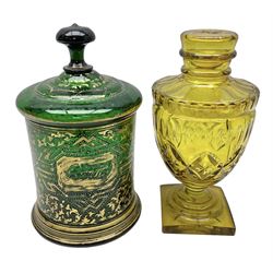 Victorian green glass lidded biscuit jar, with gilt foliate decoration and an amber glass goblet and cover,
tallest H25cm