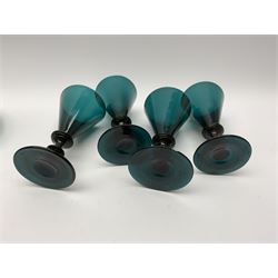 19th century green glass ships decanter with flat topped stopper, H21.5cm, together with a set of four 19th century green glass wine glasses, the funnel bowls upon bladed knopped stems and circular feet, H13cm