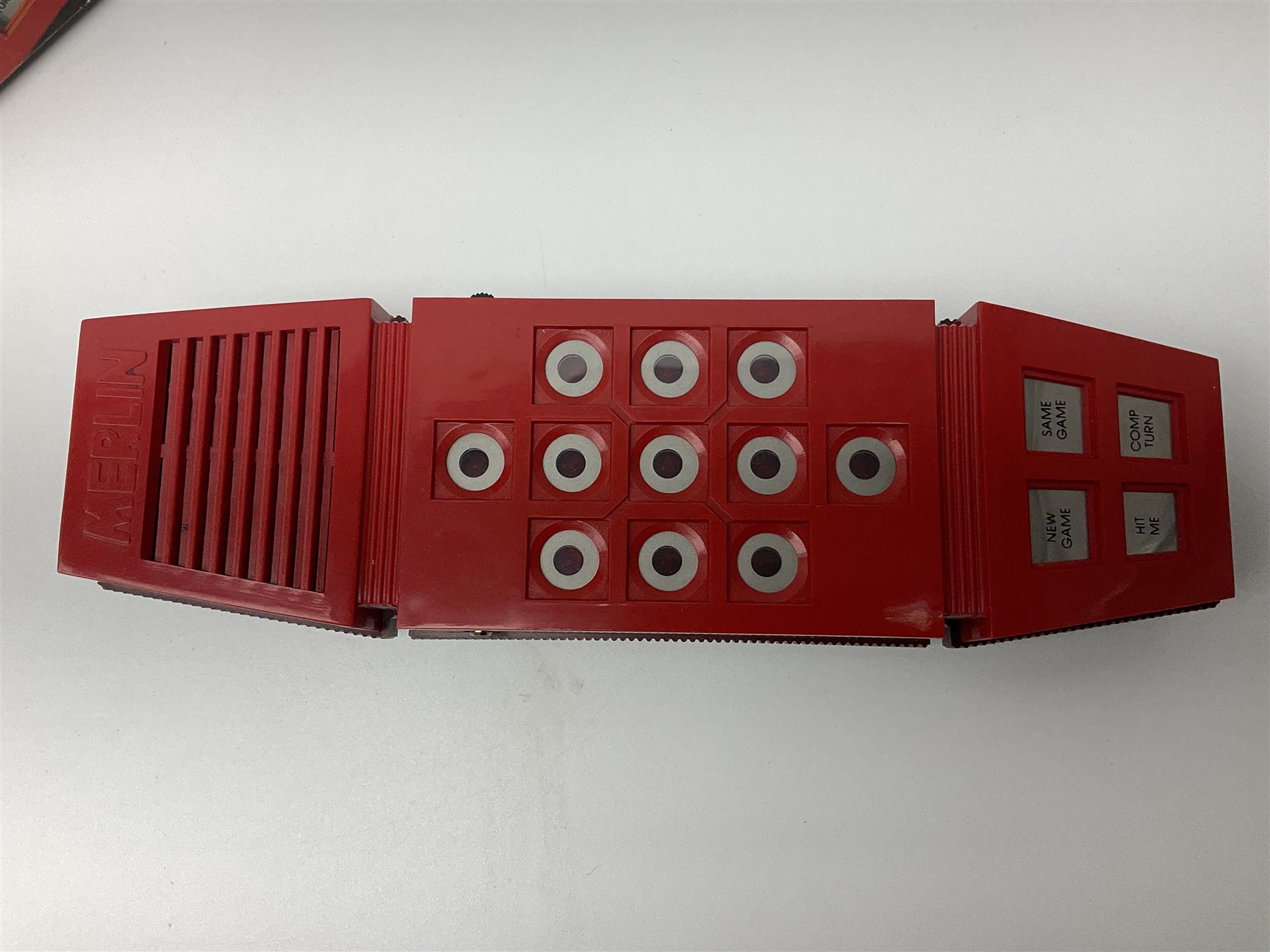 Three late 70s/early 80s handheld electronic games; Bandai Electronics Arcade ‘Gunfighter’ (1980), Grandstand ‘Invader From Space’ (1980), Palitoy ‘Merlin The Electronic Game Machine’ (1979) with game sheet and instruction booklet, all with original boxes (3) 