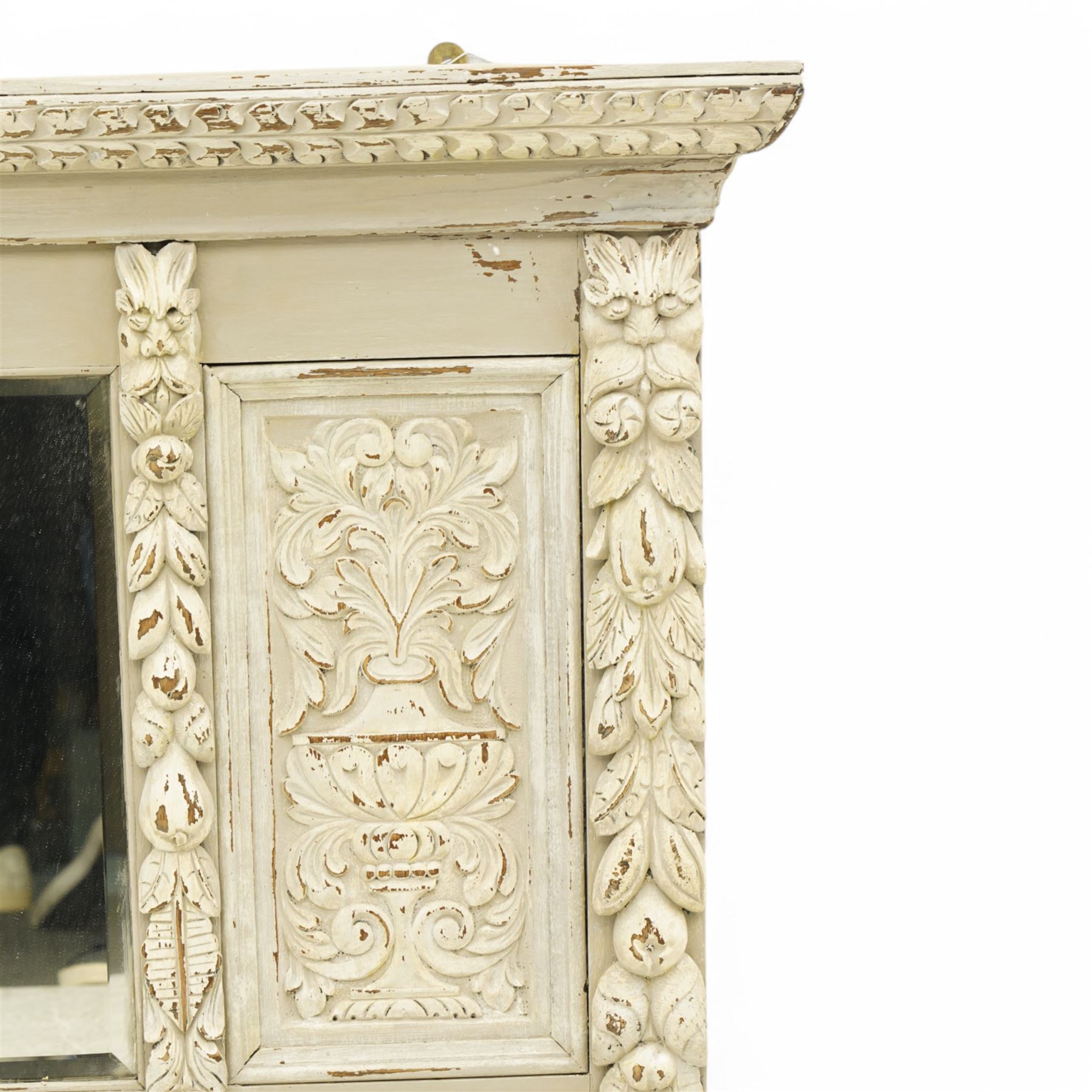 Victorian heavily carved oak wall mirror in distressed grey paint finish, moulded and chip carved cornice over central bevelled mirror and panelled front, the panels carved with urns and scrolled foliage, the uprights with fruiting foliage carved mounts 