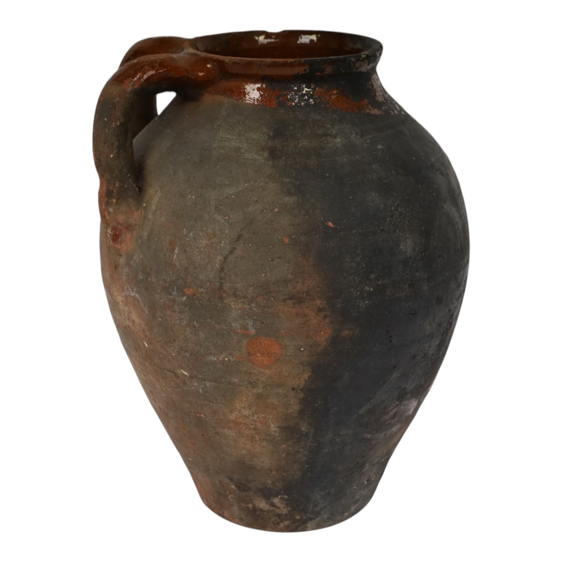 Three early 20th century Spanish part glazed terracotta storage vessels, the first example of bellied form with rounded base and twin loop handles, H24cm, the second of baluster for with close set loop handles, H30cm, and the third smaller also of baluster form with single loop handle, H24cm