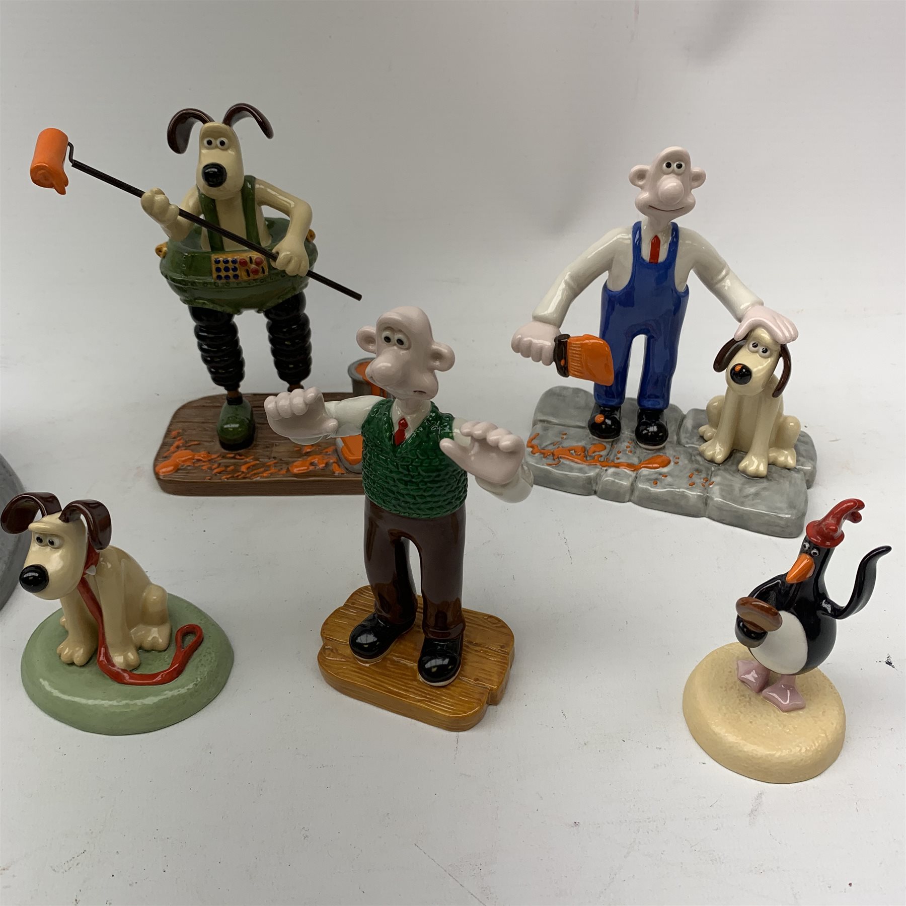 A group of six Coalport Wallace & Gromit figurines, comprising 'Hold on Gromit' no880/2000 with certificate, 'Decorating in Techno Trousers' no1195/2000 with certificate, 'Reading for Take Off', 'Do something Gromit', 'Feathers in disguise', 'Happy Birthday Gromit', each in maker's box with accompanying swing tag.