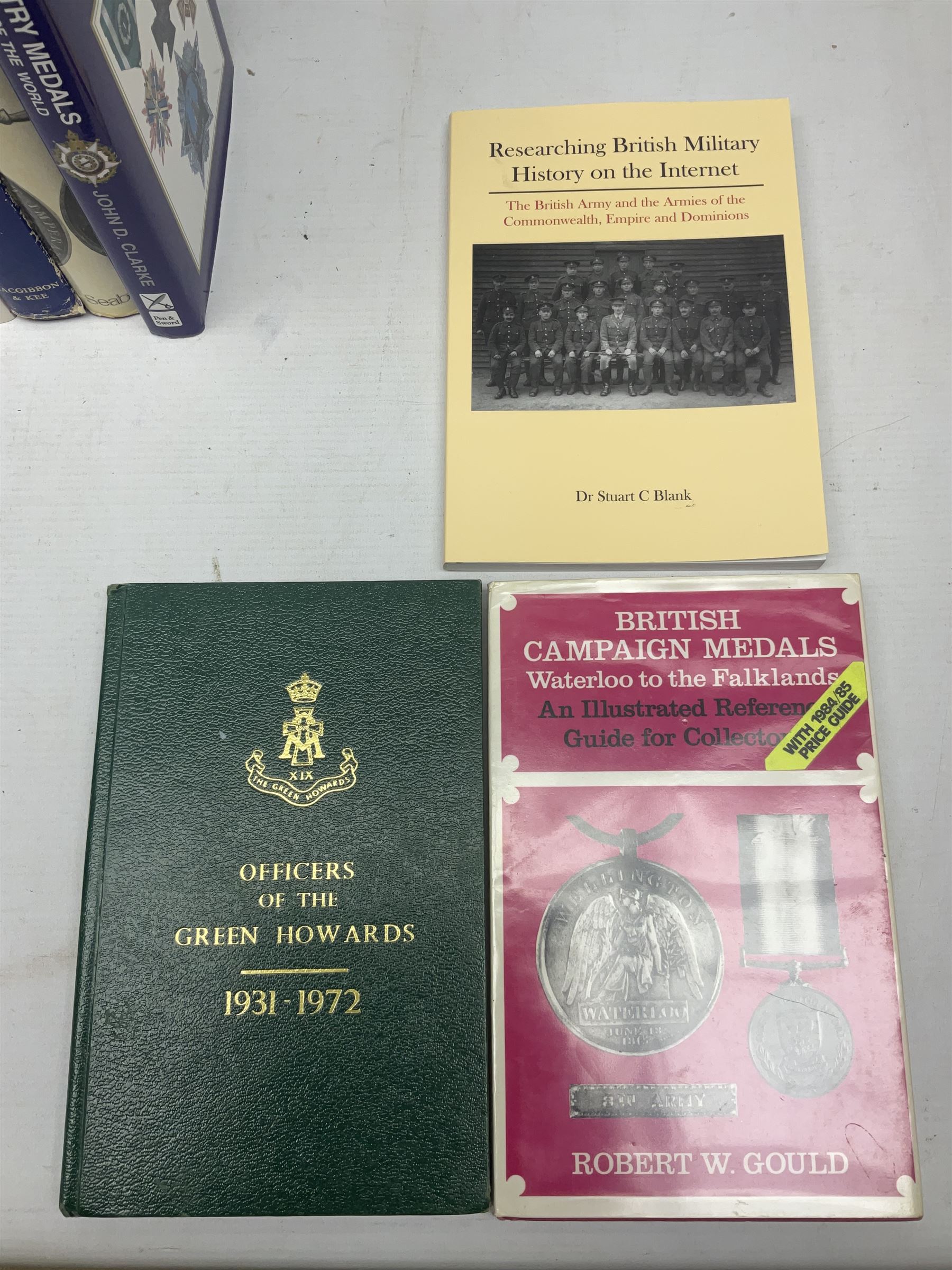 Eleven medal reference books including Ian Bisset: The George Cross; Spinks British Battles & Medals; William Spencer: Medals - The Researchers Guide; John D. Clarke: Gallantry Medals & Decorations of the World; Officers of The Green Howards 1931-1972; and six others (11)