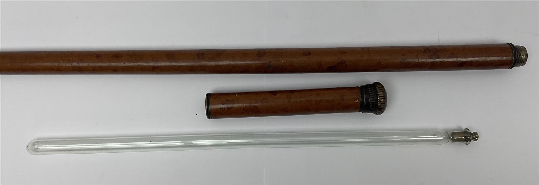 19th century malacca walking cane, the screw threaded domed cover opening to reveal vacant recess, above a further screw threaded opening revealing a removable glass vial with stopper, glass vial L41cm, cane L89.5cm
