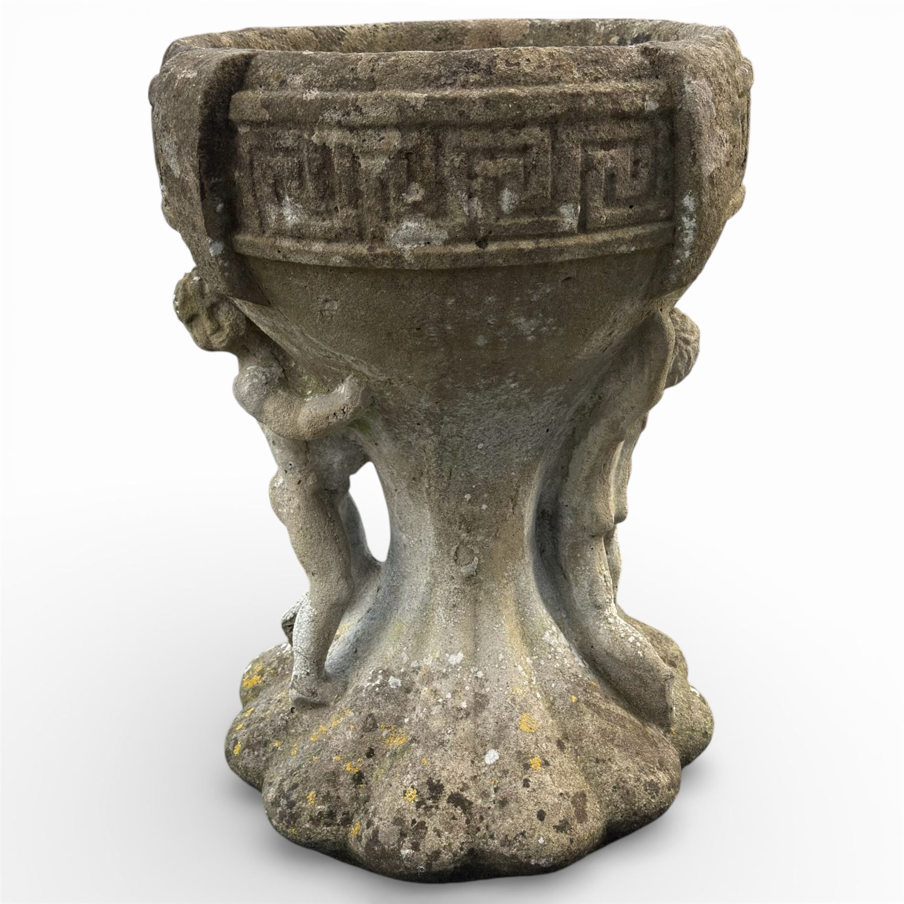 Cast stone urn with two figures supporting the bowl