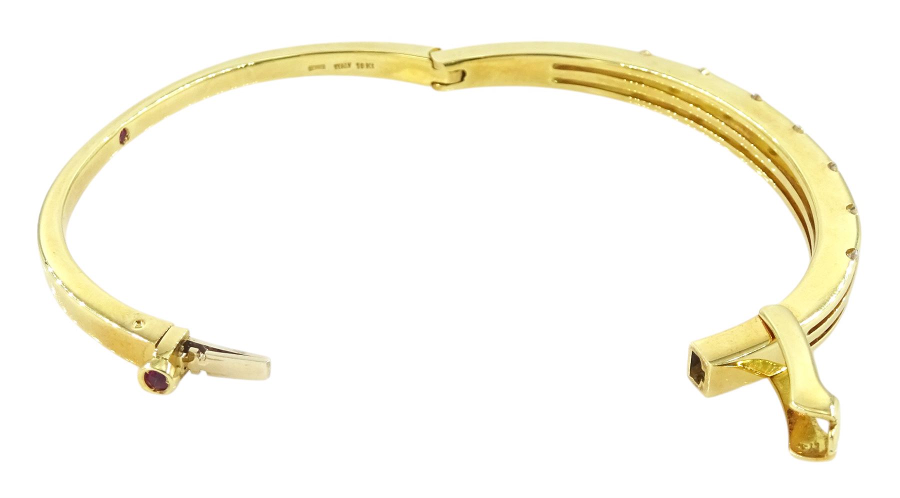 Roberto Coin 'Parisienne' 18ct gold three row round brilliant cut diamond bangle, with a signature round cut ruby to the underside and ruby set clasp, Birmingham 2006, boxed