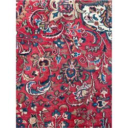 Large Persian Kashan carpet, red ground and decorated all-over with interlacing foliate and flower heads, central floral medallion, multi-band border with scrolling design 