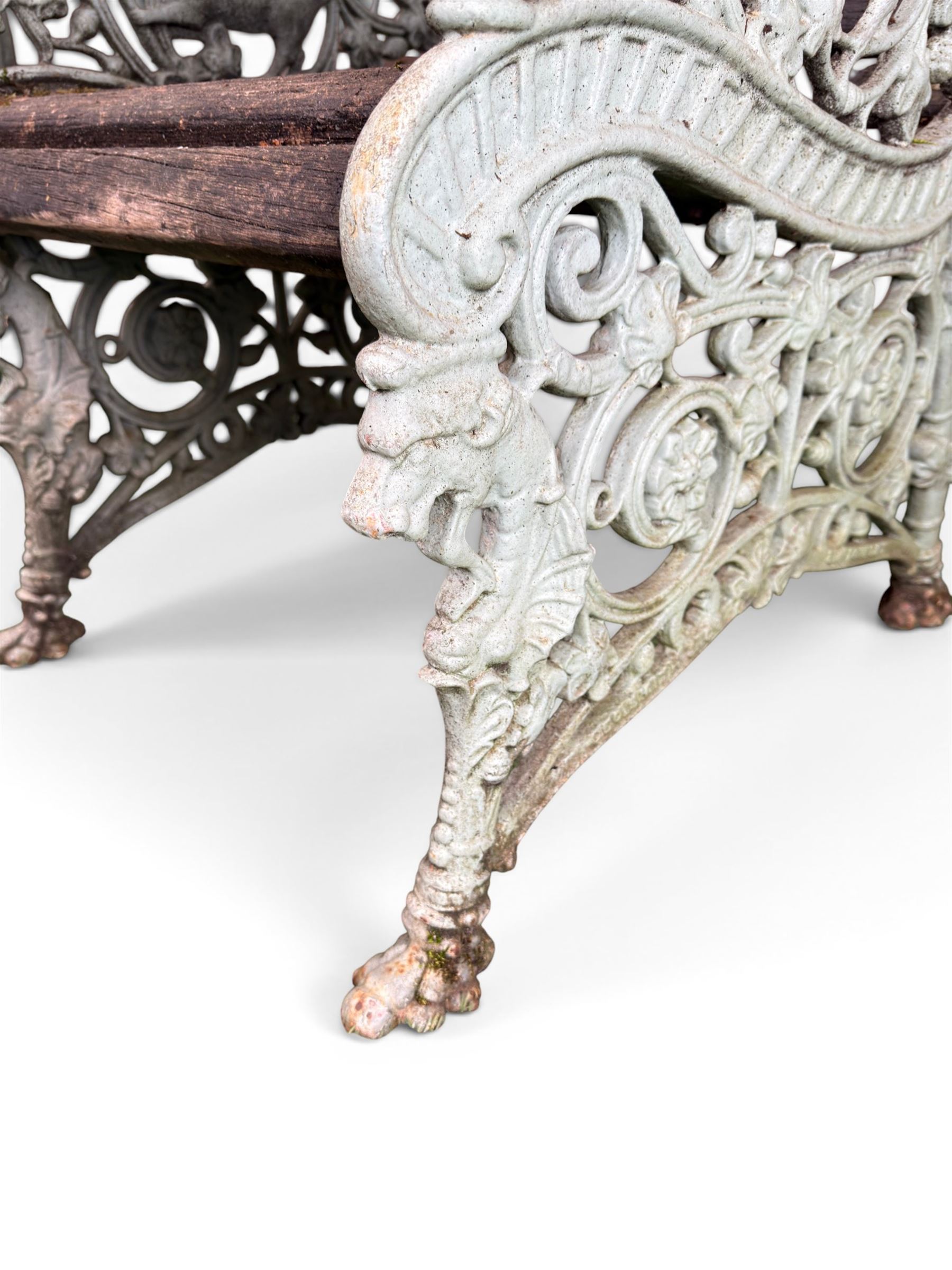 Pair of unusual Victorian revival heavy cast iron garden chair benches, ornate scrollwork detail with squirrels and nature, serpentine wood slatted seat and back - design by George Smith at the Sun Foundry, Glasgow