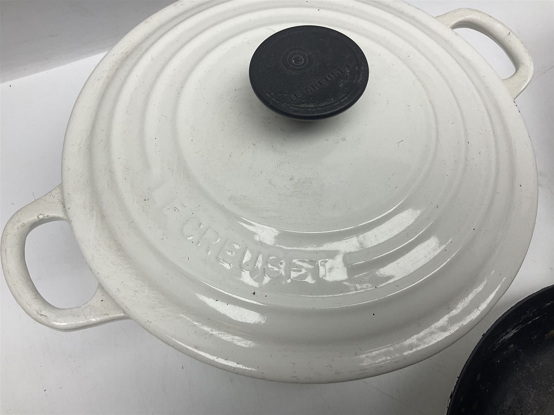 Le Creuset cast iron casserole dish, together with two Waterford cast iron dishes and a frying pan