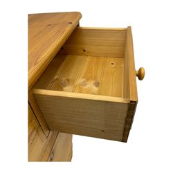 Pine chest of drawers topped with carved pediment with acorn and oak leaf motif, fitted with two short over three long drawers, standing on shaped apron base (W92, D46, H97cm); pine bedside cabinet, single drawer above paneled cupboard door enclosing open storage, shaped plinth base (W43, L32, H67cm)