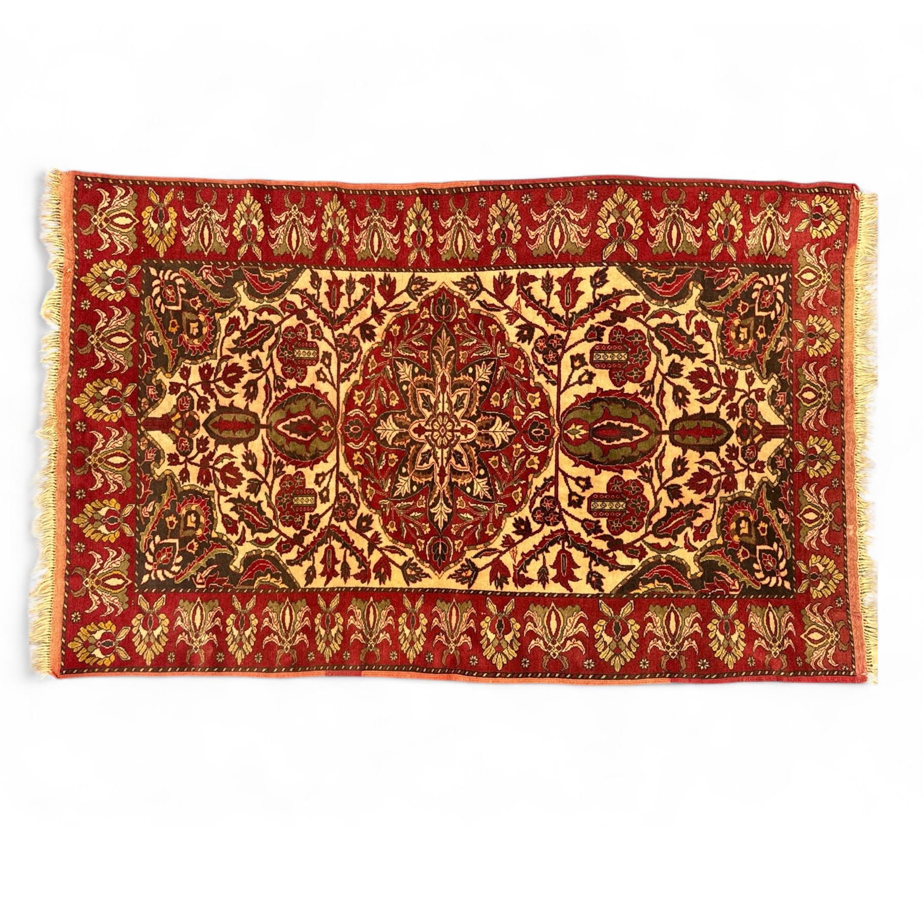 Persian Kerman hand-knotted rug, ivory and crimson ground, central medallion surrounded  by a floral foliate pattern, main border with repeating design of floral cartouches and palmettes, and narrow vine work guard border  