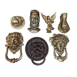 Seven novelty door knockers, including cast iron lion mask, brass hand, brass bulldog and four other brass examples
