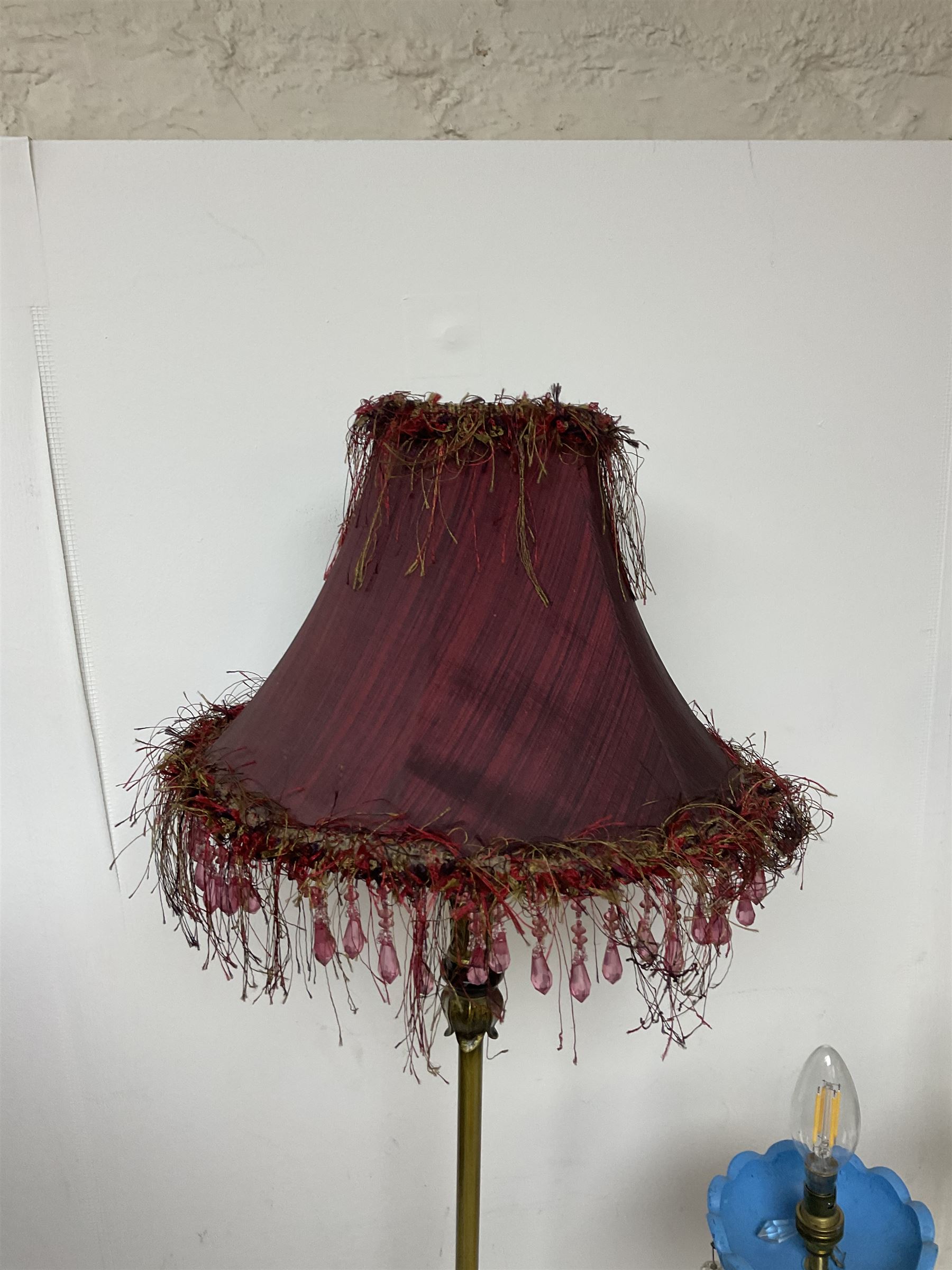 Brass table lamp, modelled as a candelabra with five branches, each with blue glass candle holders with crystal drops, H47cm, together with a pair of cast metal table lamps with acanthus leaf detail, upon a stepped square base, with red fabric feather and tassel shades, H78cm