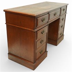 Late Victorian oak nine drawer desk, the rectangular top inset with a tooled leather writing surface bordered in gilt, above three frieze drawers and two pedestal cupboards each fitted with three graduated drawers, all with brass swan neck handles, raised on plinth bases