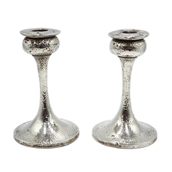  Pair of silver Arts & Crafts candlesticks, spot hammered decoration by S Blanckensee & Son Ltd, Birmingham 1923, H14.5cm   