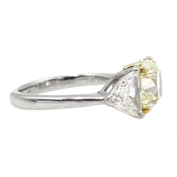  Platinum three stone diamond ring, the centre fancy light yellow cushion cut diamond of approx 1.70 carat with two white trillion cut diamonds either side, each weighing approx 0.60 carat, hallmarked, total carat weight approx 2.90 carat  