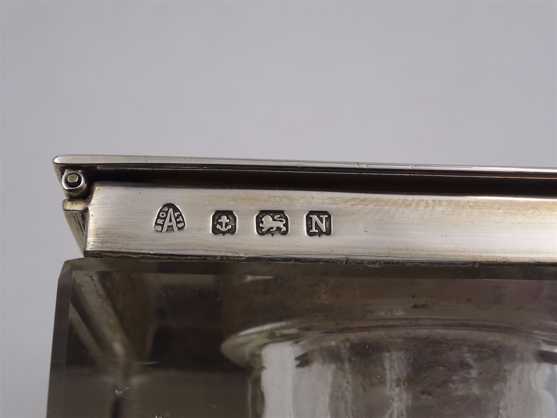 1930s silver mounted glass inkwell, of square form, the silver lid with engine turned decoration and engraved initials, hallmarked Adie Brothers Ltd, Birmingham 1937, H4.7cm