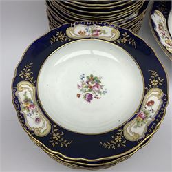 Late Victorian part dinner service, comprising venison platter, meat drainer and platter, six graduating serving platters, two twin handled open tureens, twin handled sauce tureen with cover and saucer, covered serving dish twelve dinner plates, twelve side plates, twelve soup bowls and eleven dessert plates, hand painted with floral sprigs within a cobalt blue border with floral panels, and heightened in gilt