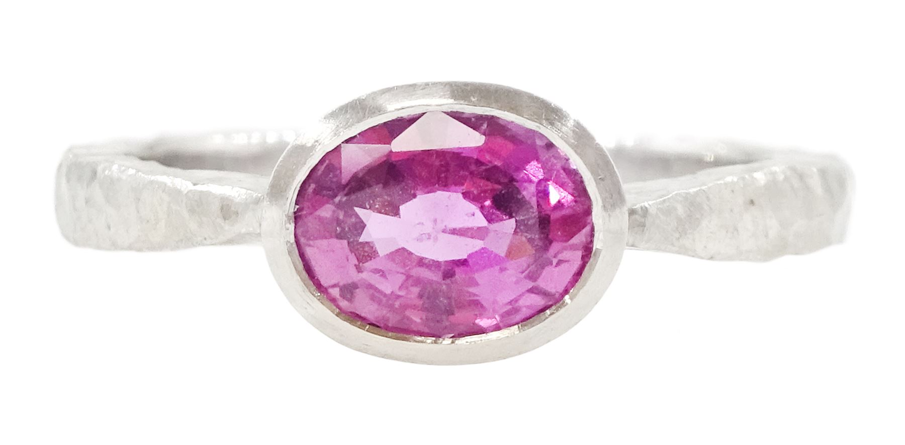 Platinum pink sapphire ring, single bezel set sapphire of approx 1.40 carat, to a planished shank, London 2019