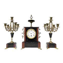 French mantle clock c.1900 with two matching five light candelabra, eight-day timepiece movement housed in a rectangular flat topped Belgium slate case surmounted by a conforming slate and brass finial, contrasting marble inlay to the front with incised decoration, raised on four paw feet, 4” enamel dial, Roman numerals and minute markers, steel moon hands within a cast bezel with a flat bevelled glass. 
H41 W20 D13  Candelabra  H36


