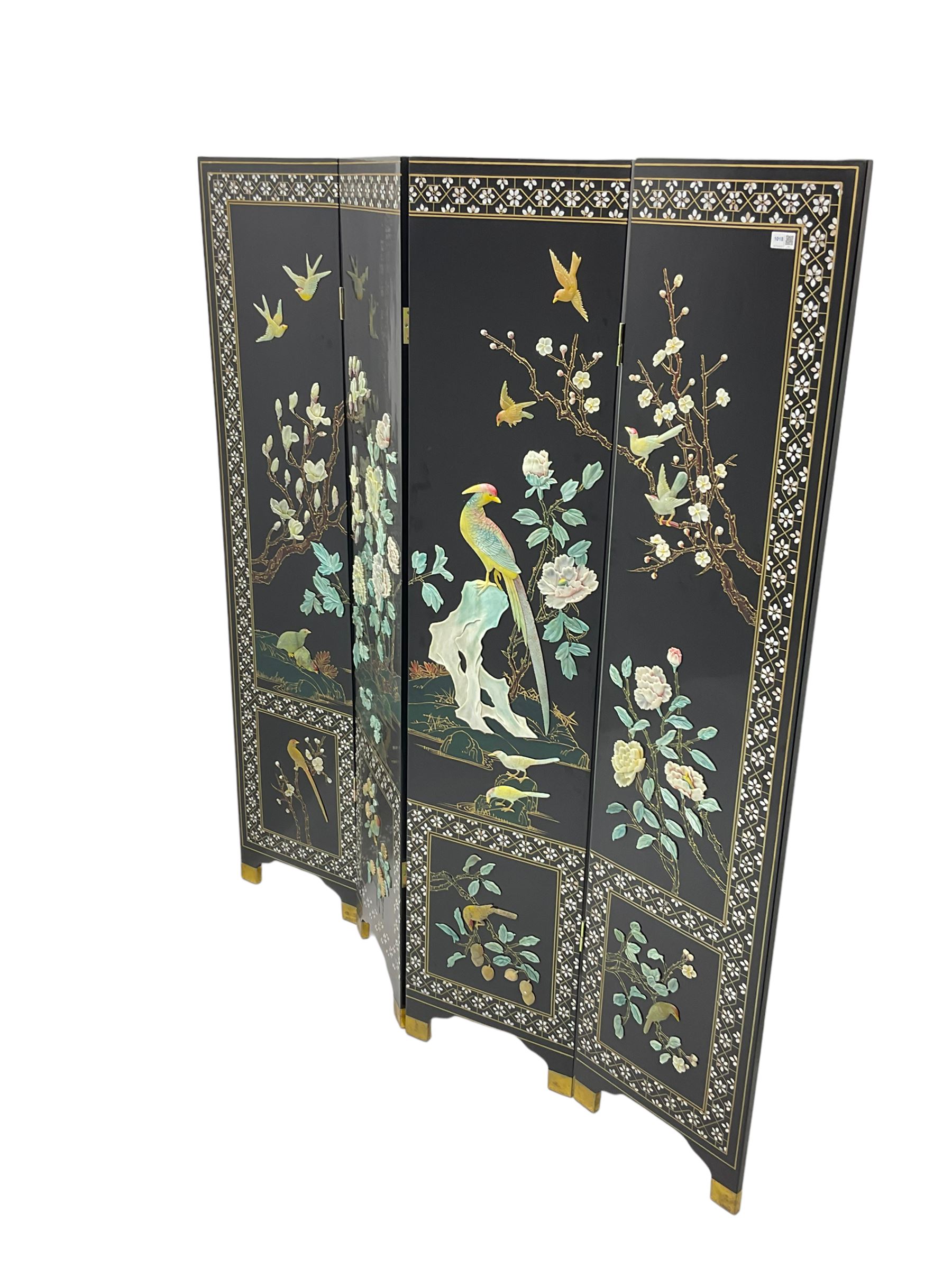 Japanese Shibayama style black lacquered four panel folding screen, naturalist scenes of trailing branch and blossom flowers, decorated with with birds, floral mother of pearl inlaid borders