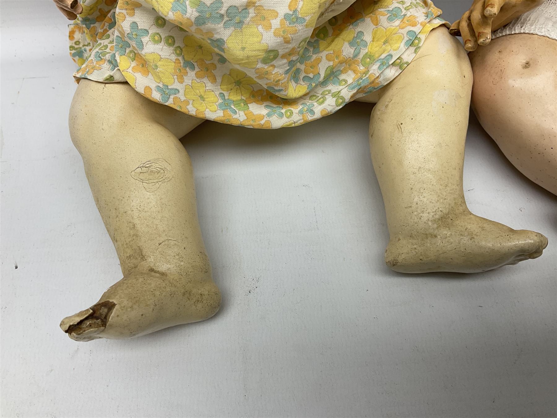Carl Harmus Germany bisque head doll with applied hair, sleeping eyes, open mouth with teeth and composition body with jointed limbs; marked 'Harmus 313.4/0 Germany' H38cm; and Alt, Beck & Gottschalk Germany bisque head doll with applied hair, fixed eyes, open mouth with tongue and composition body with jointed limbs H44cm (2)