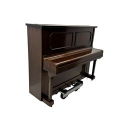 Waddington - Edwardian mahogany upright piano, rectangular top with panelled front, rounded key cover, makers name on fallboard, raised on bracket supports with castors
