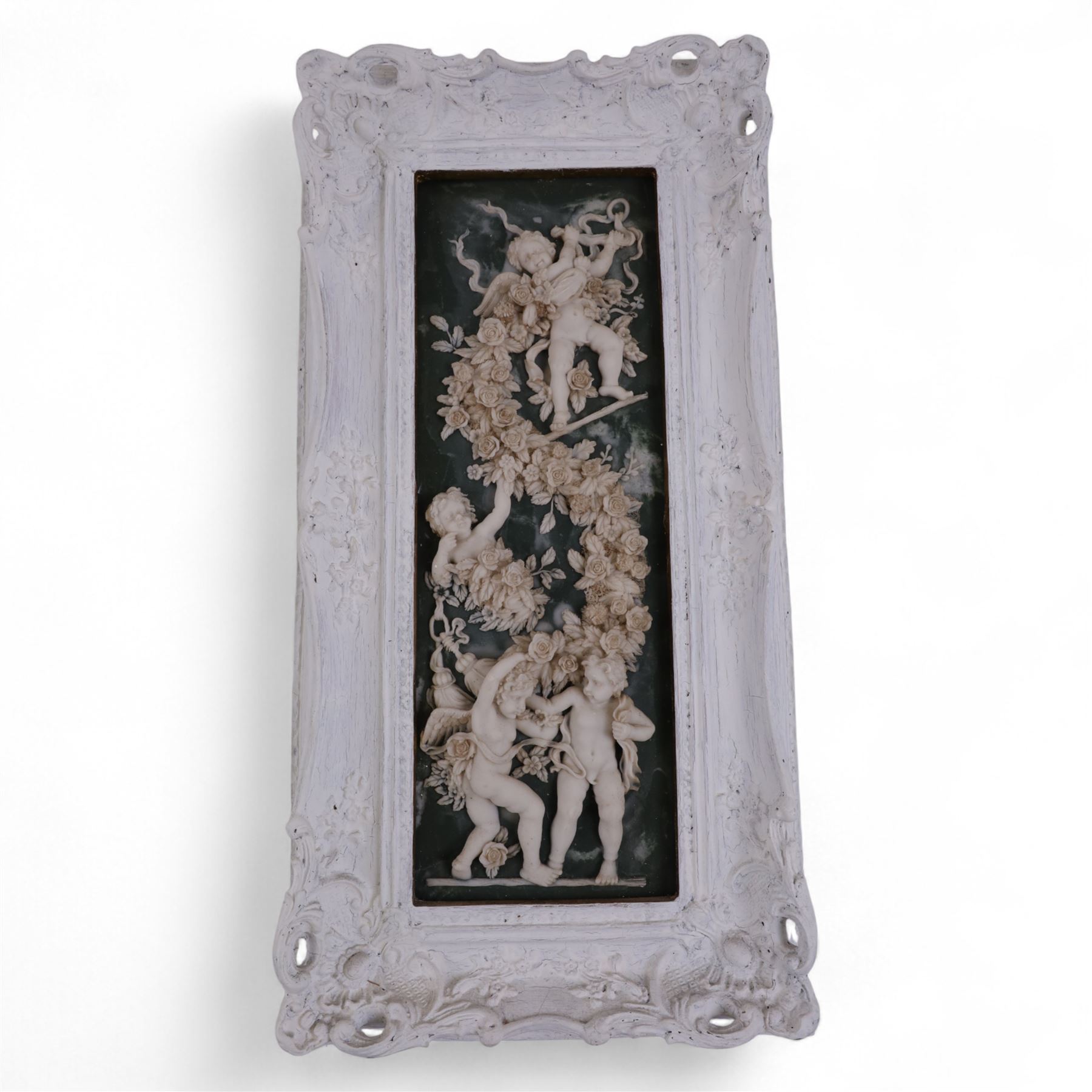 Composite plaque decorated in relief with putti amongst flowering roses, together with similar framed example and two others, framed H56cm, W28cm