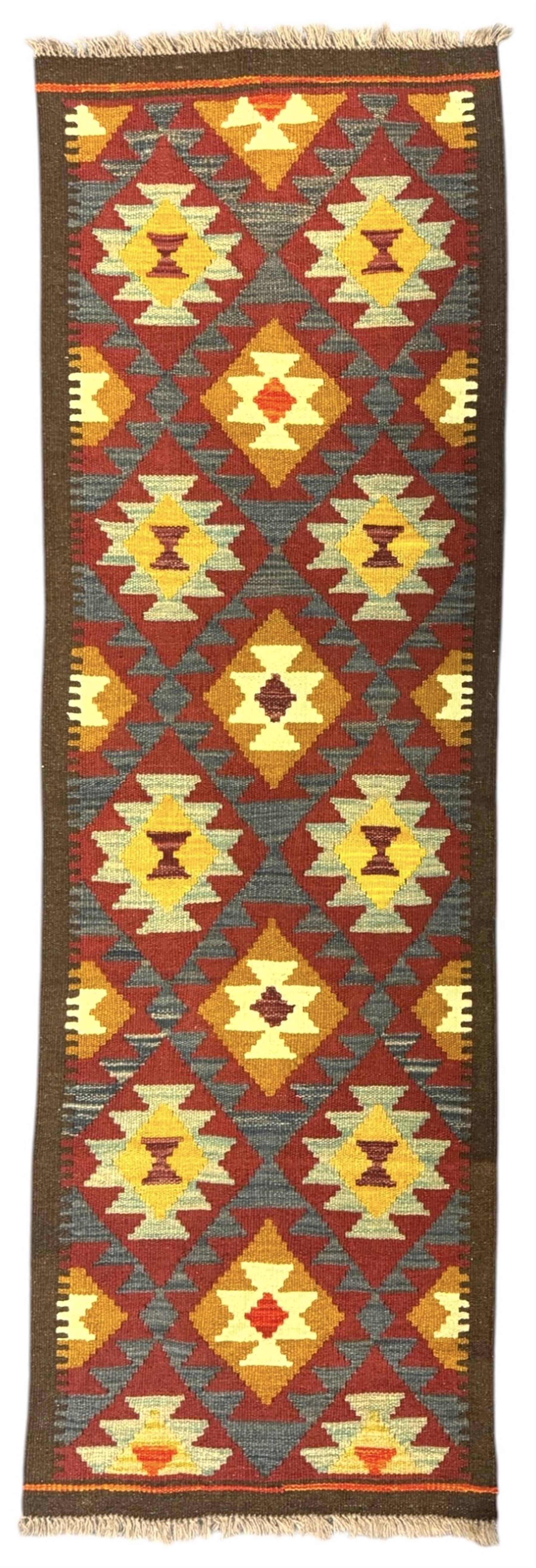 Maimana Kilim ground runner, multicoloured geometric medallions arranged in rows, with triangular motifs in the field, the wide border in brown with contrasting guard bands