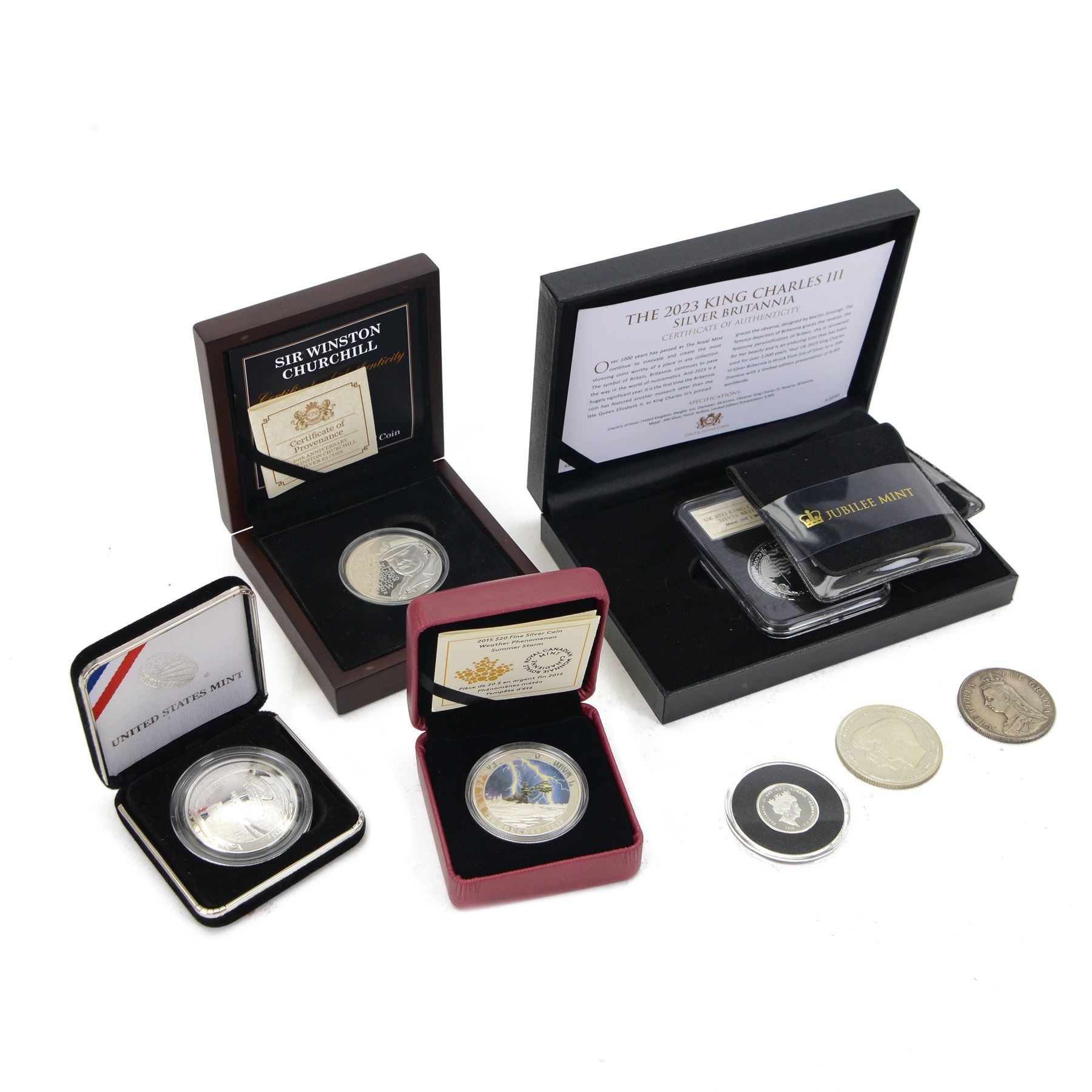 Great British and World silver coins, comprising King Charles III 2023 fine silver one ounce Britannia, Queen Elizabeth II Jersey 2015 'Churchill' silver proof five pound coin, three silver proof one pound coins, United States Mint 2019 'Apollo 11' silver proof one dollar coin, Royal Canadian Mint 2015 'Summer Storm' fine silver twenty dollar coin, Queen Victoria 1887 silver one crown coin, and London Mint 2005 'Prince of Wales and Duchess of Cornwall' prototype
