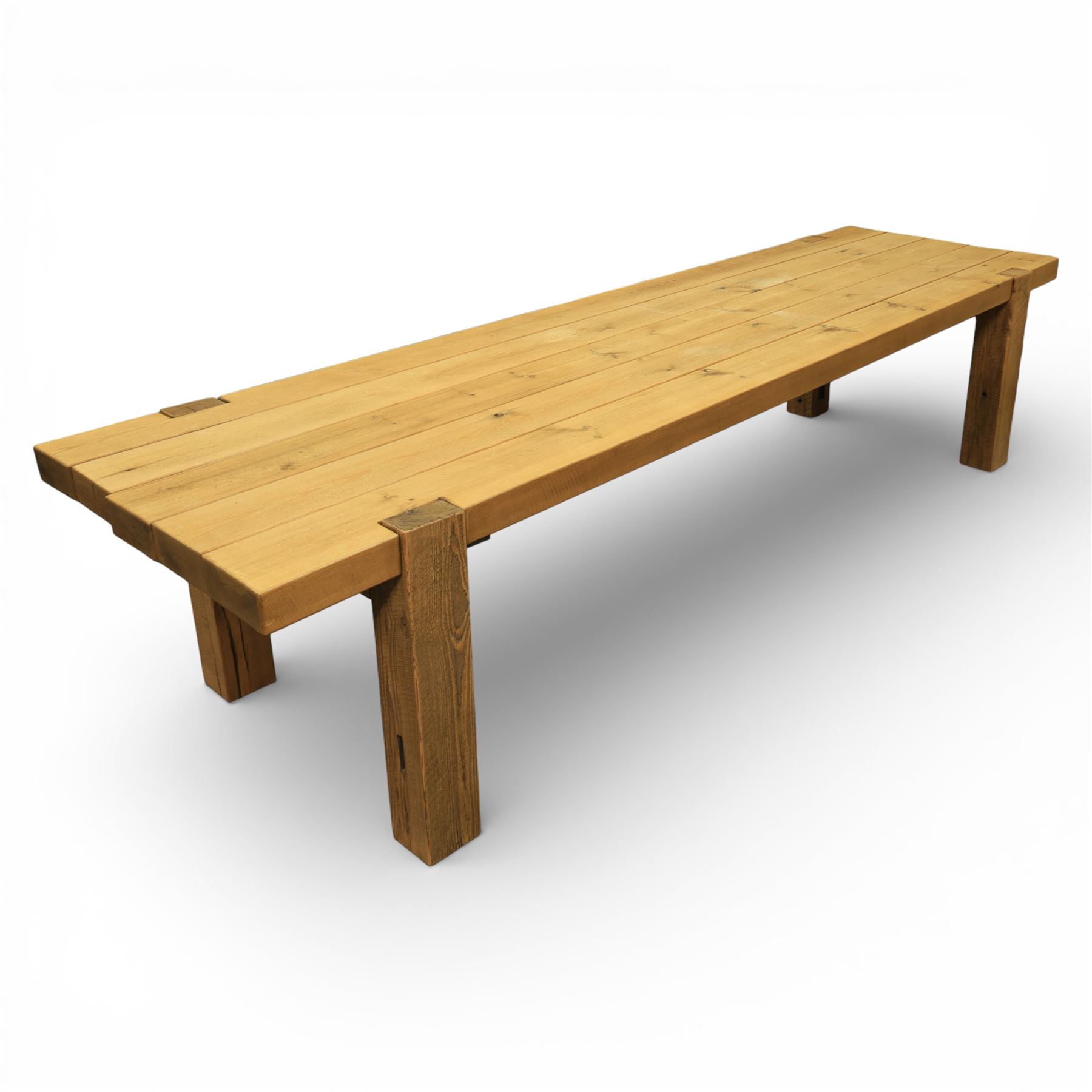 Modern large oak plank top dining table and twelve brown leather high back chairs, table of rustic construction five solid planks with exposed supports, the chairs in brown leather hide with ten standard height and a pair of taller chairs for the foot and head of the table