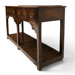 George III oak dresser base, rectangular top with moulded edge, fitted with two drawers over shaped spandrels, raised on square chamfered supports united by undertier, on stile feet